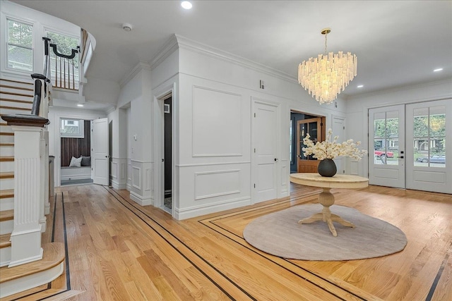 180 Union St, Montclair, NJ 07042 - entryway with stairs, light wood finished floors, a chandelier, crown molding, and a decorative wall