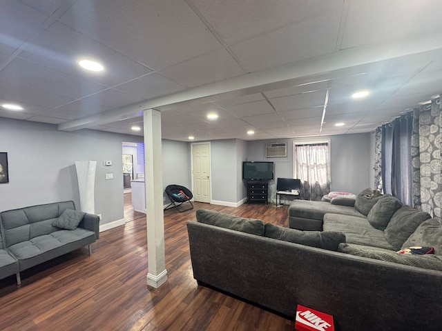 living room with recessed lighting, a drop ceiling, dark wood finished floors, and baseboards