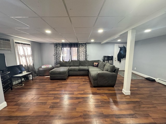 living room with a paneled ceiling, baseboards, wood finished floors, and recessed lighting