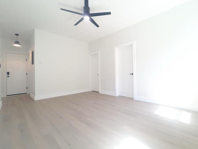 368 Palisade Ave, Jersey City, NJ 07307 - empty room featuring light wood-style flooring, a ceiling fan, and baseboards