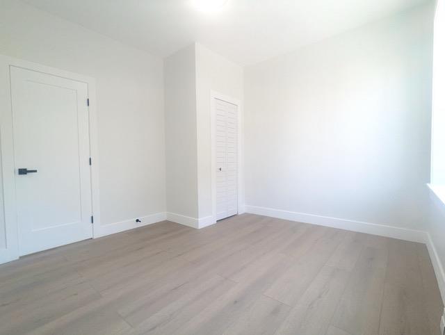 368 Palisade Ave, Jersey City, NJ 07307 - unfurnished bedroom featuring light wood-style flooring and baseboards