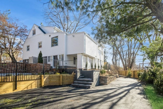 view of front facade with fence and a wooden deck