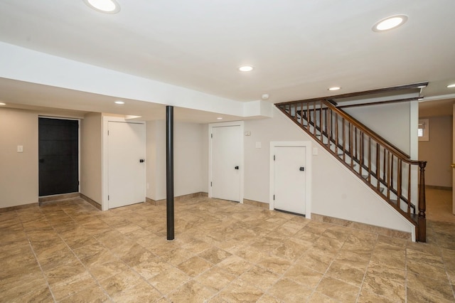 finished below grade area featuring stairs, recessed lighting, and baseboards