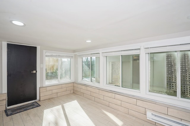 unfurnished sunroom with a baseboard radiator