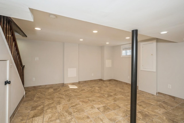 below grade area featuring stairway, recessed lighting, and stone finish flooring