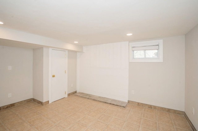 below grade area featuring light tile patterned flooring and recessed lighting