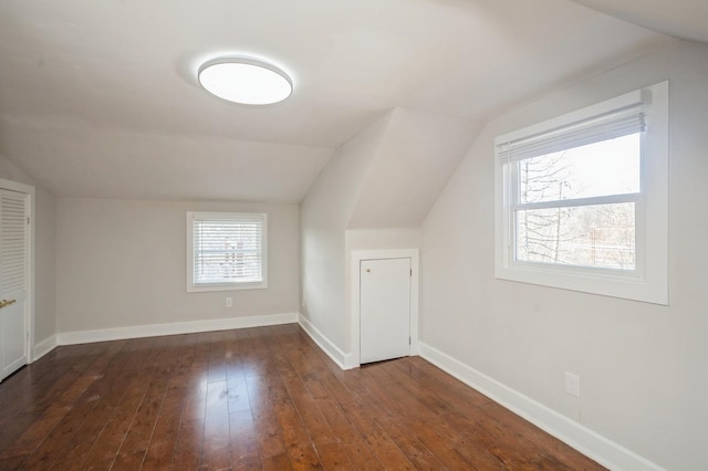 additional living space featuring lofted ceiling, baseboards, and hardwood / wood-style flooring