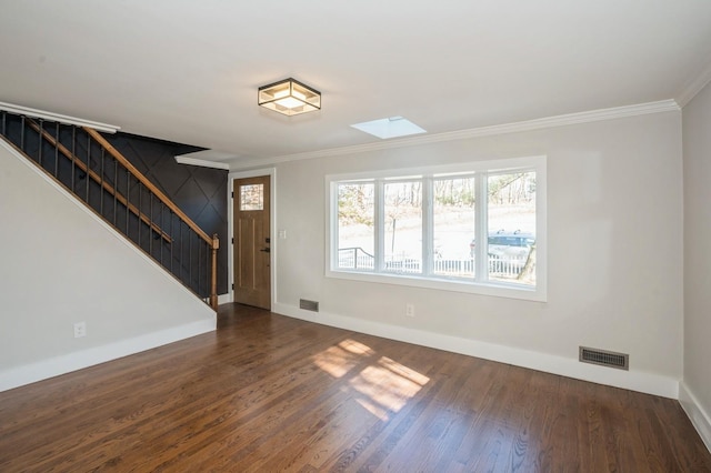 unfurnished living room with visible vents, crown molding, stairs, and dark wood-type flooring