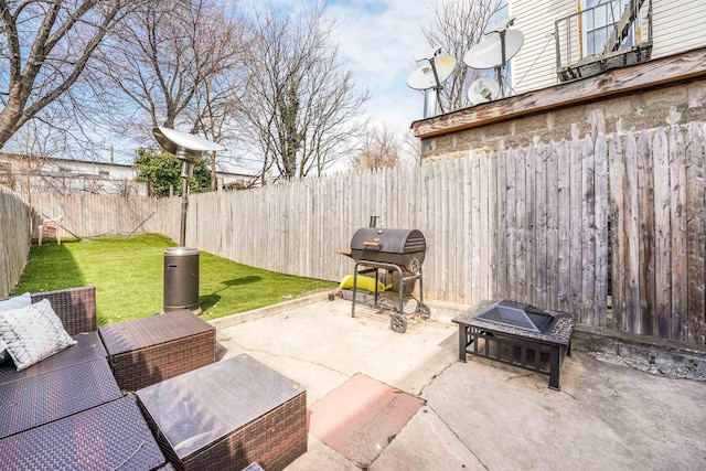 view of patio with a fenced backyard, an outdoor fire pit, and grilling area