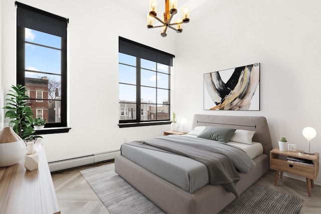 bedroom with multiple windows, a notable chandelier, and baseboard heating