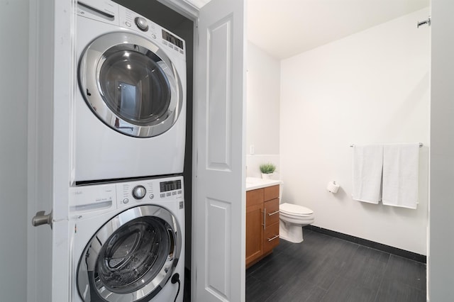 1500 Hudson St Unit 7U, Hoboken, NJ 07030 - laundry area with estacked washer and dryer and baseboards