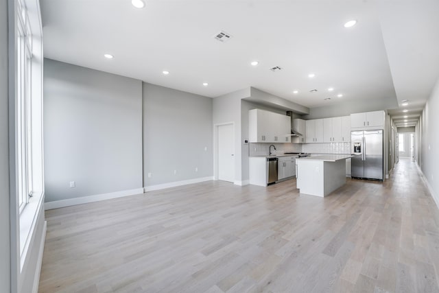 810 6th St Unit 2, Union City, NJ 07087 - kitchen featuring appliances with stainless steel finishes, a kitchen island, light countertops, open floor plan, and tasteful backsplash
