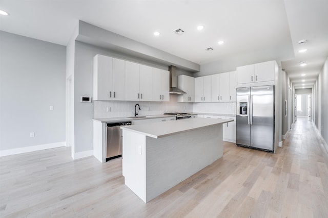 810 6th St Unit 2, Union City, NJ 07087 - kitchen featuring stainless steel appliances, wall chimney exhaust hood, light countertops, light wood-type flooring, and recessed lighting