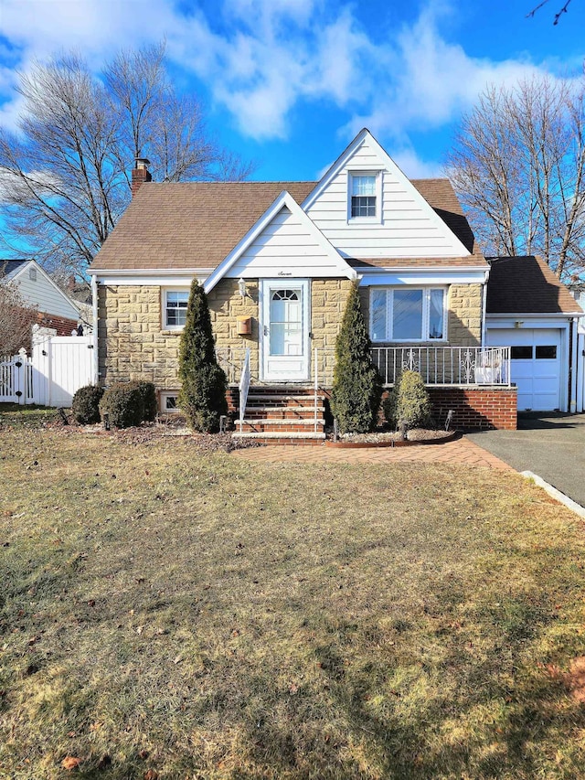 view of front of home with a garage and a front yard