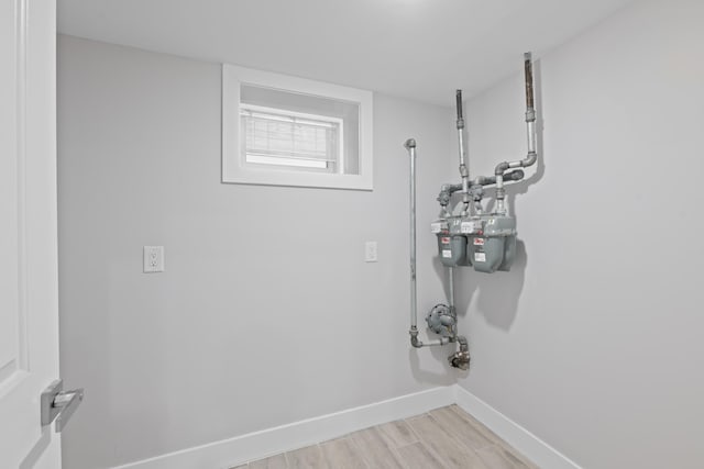 laundry room with light hardwood / wood-style flooring