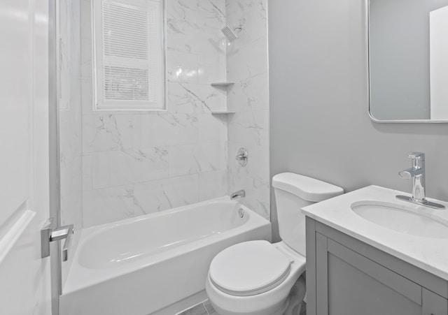 full bathroom featuring toilet, vanity, and tiled shower / bath