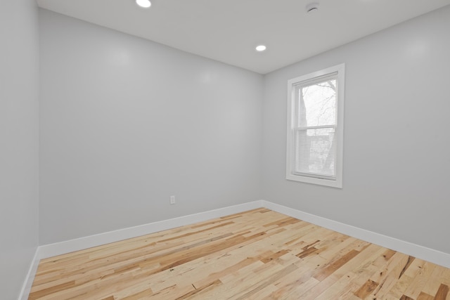 spare room with hardwood / wood-style floors