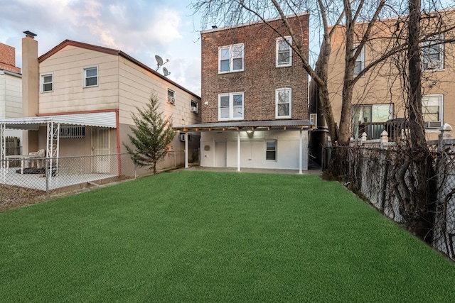 rear view of property with a yard