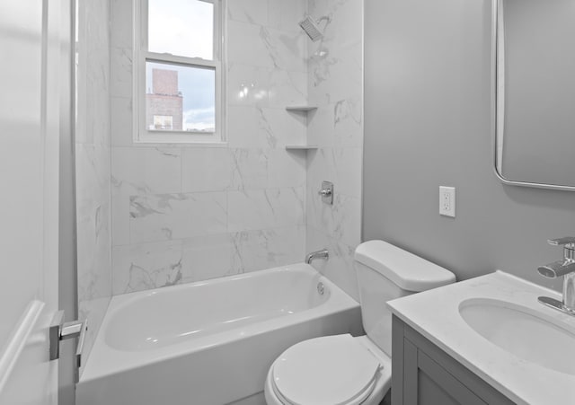 full bathroom featuring vanity, tiled shower / bath combo, and toilet