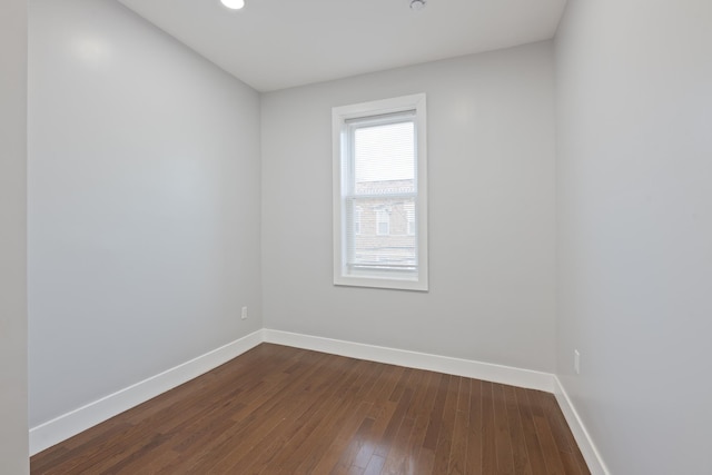 empty room with dark hardwood / wood-style floors