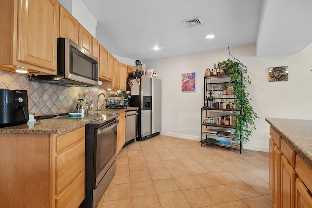 311 Palisade Ave Unit 3B, Jersey City, NJ 07307 - kitchen with stainless steel appliances, decorative backsplash, light brown cabinets, light tile patterned floors, and light stone counters