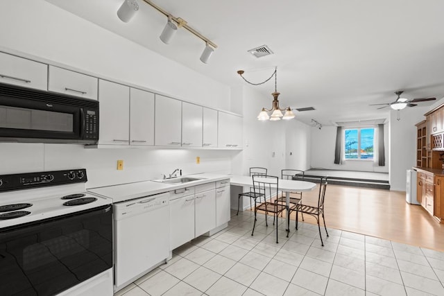 kitchen with black microwave, range with electric cooktop, a sink, visible vents, and dishwasher