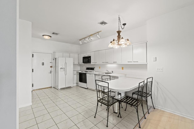 kitchen with a peninsula, white appliances, a sink, visible vents, and light countertops