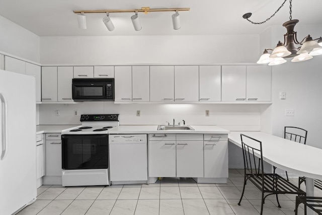 kitchen featuring light countertops, an inviting chandelier, white cabinetry, a sink, and white appliances