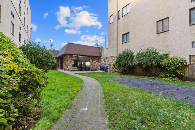 surrounding community featuring a yard and fence