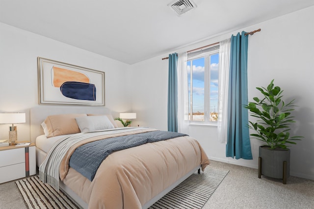 bedroom featuring light carpet and visible vents