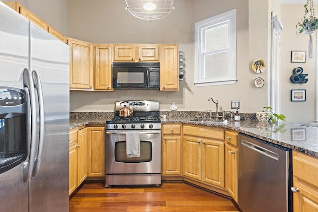 314 Palisade Ave Unit 3, Jersey City, NJ 07307 - kitchen featuring appliances with stainless steel finishes, a sink, wood finished floors, and dark stone counters