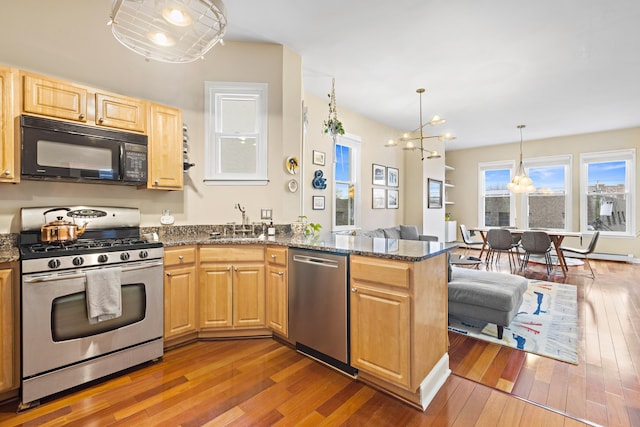 314 Palisade Ave Unit 3, Jersey City, NJ 07307 - kitchen featuring stainless steel appliances, a chandelier, a peninsula, hardwood / wood-style floors, and a sink