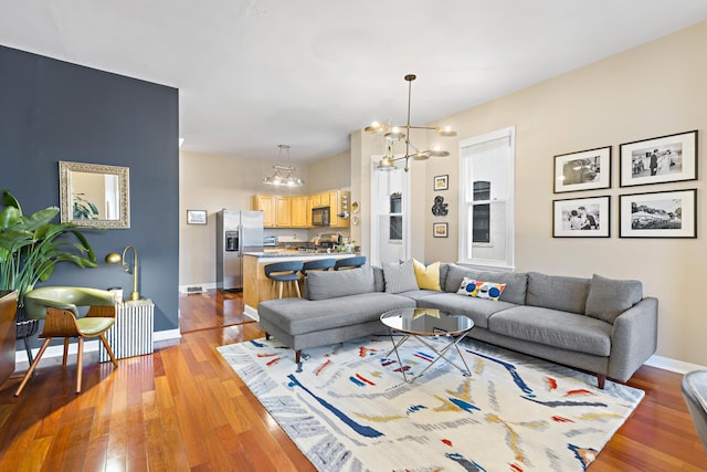 314 Palisade Ave Unit 3, Jersey City, NJ 07307 - living room with a chandelier, light wood-style flooring, and baseboards