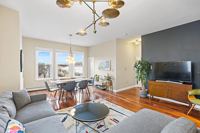 314 Palisade Ave Unit 3, Jersey City, NJ 07307 - living area featuring a chandelier, wood finished floors, baseboards, and baseboard heating