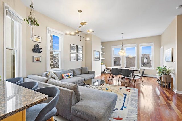 314 Palisade Ave Unit 3, Jersey City, NJ 07307 - living area with a chandelier, dark wood-type flooring, and baseboards