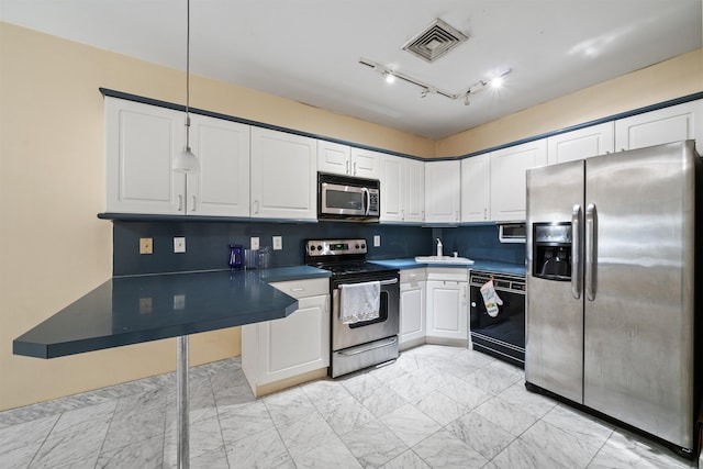 75 Liberty Ave Unit E13, Jersey City, NJ 07306 - kitchen with appliances with stainless steel finishes, white cabinets, dark countertops, light marble finish floors, and decorative backsplash