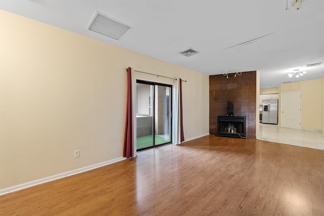 75 Liberty Ave Unit E13, Jersey City, NJ 07306 - unfurnished living room with light wood-style flooring and a large fireplace