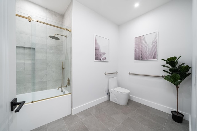 bathroom with combined bath / shower with glass door, tile patterned floors, and toilet