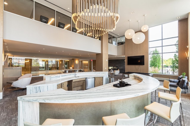 kitchen featuring a towering ceiling and sink