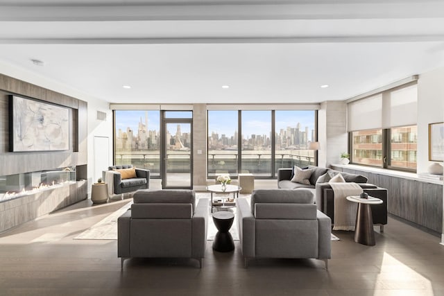 living room featuring wood-type flooring and floor to ceiling windows