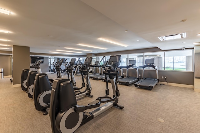 exercise room featuring light colored carpet