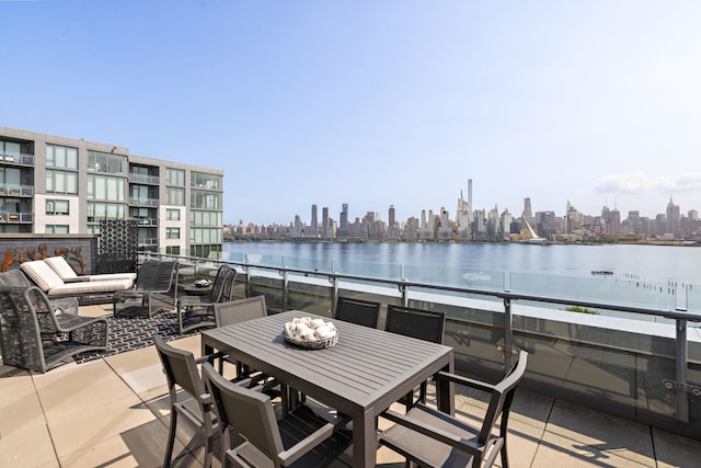 view of patio featuring a water view and a balcony