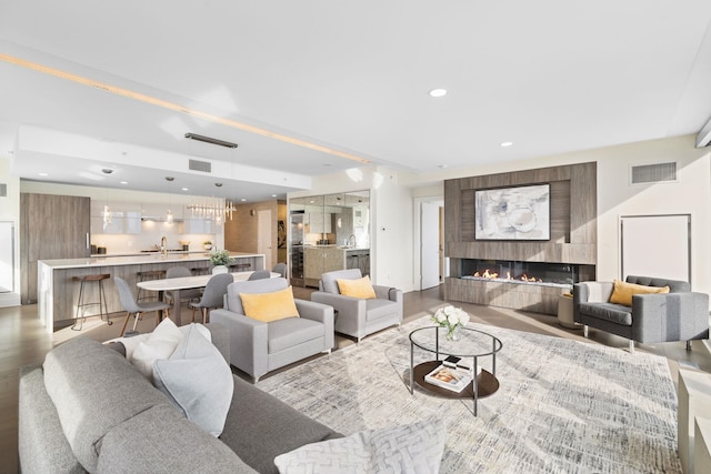 living room featuring light hardwood / wood-style floors and sink