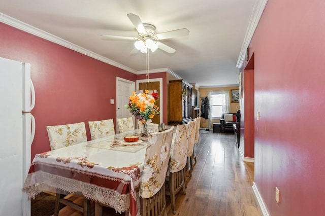 112 Astor Pl, Jersey City, NJ 07304 - dining area featuring a ceiling fan, hardwood / wood-style floors, ornamental molding, and baseboards