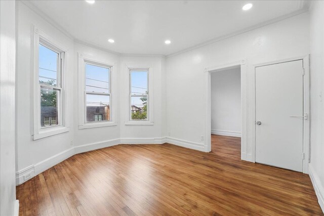 144 Nelson Ave, Jersey City, NJ 07307 - empty room with healthy amount of natural light, wood finished floors, ornamental molding, baseboards, and recessed lighting