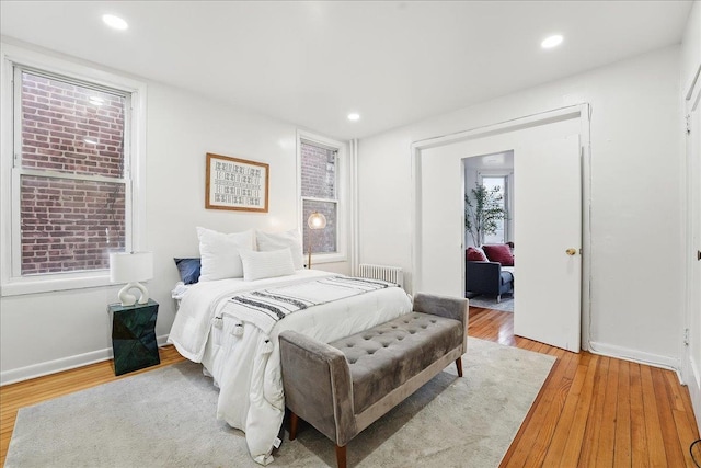 144 Nelson Ave, Jersey City, NJ 07307 - bedroom featuring radiator, light wood-style flooring, baseboards, and recessed lighting