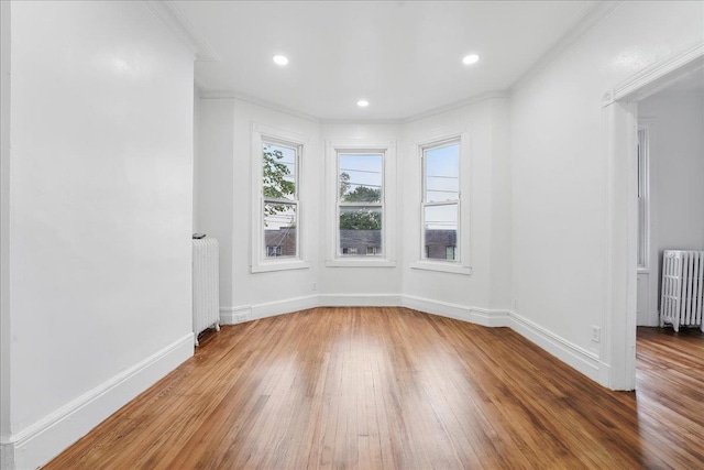 144 Nelson Ave, Jersey City, NJ 07307 - unfurnished room with radiator heating unit, hardwood / wood-style flooring, ornamental molding, baseboards, and recessed lighting