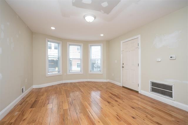 unfurnished room with recessed lighting, visible vents, baseboards, and light wood-style flooring