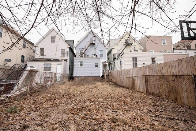 rear view of property with a fenced backyard and a residential view