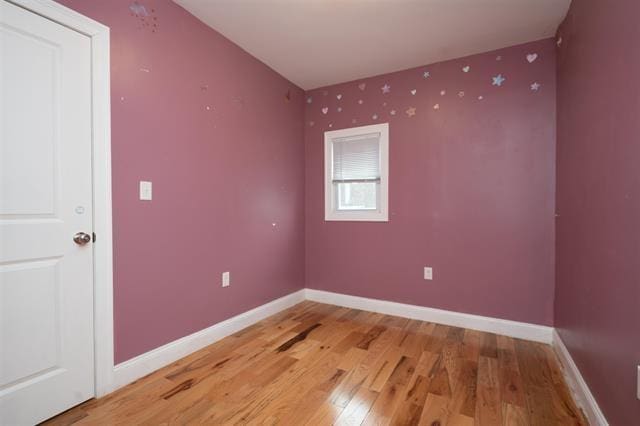 additional living space featuring light wood-style flooring and baseboards